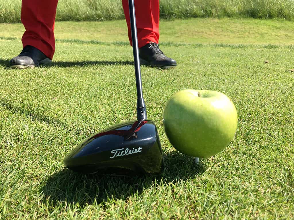 Golf club hitting an apple - nutrition for gofers