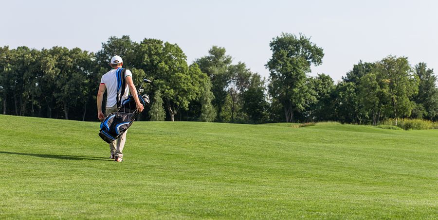 golfer-with-golf-bag-walking-down-course (1)